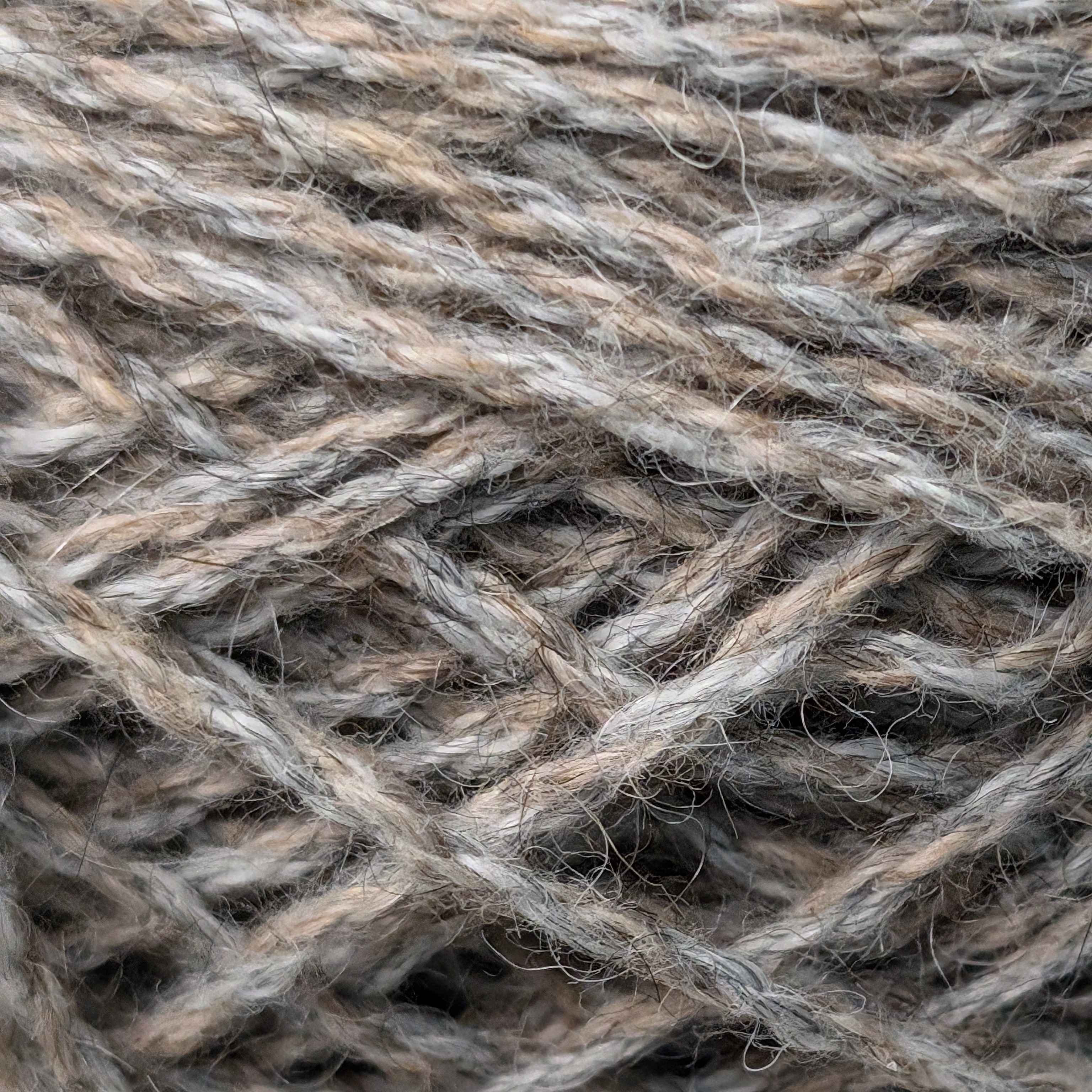 String Texture<br><br>
     A close-up of a ball of string from class. The string was awfully scratchy to touch and it felt
     similar to the yarn from the textiles class next door. These are made with natural fibres.
     The string is woven together tightly and its quality is sturdy. It can be a great substitute for
     rope. I'm not certain it would be preferable for knitting.