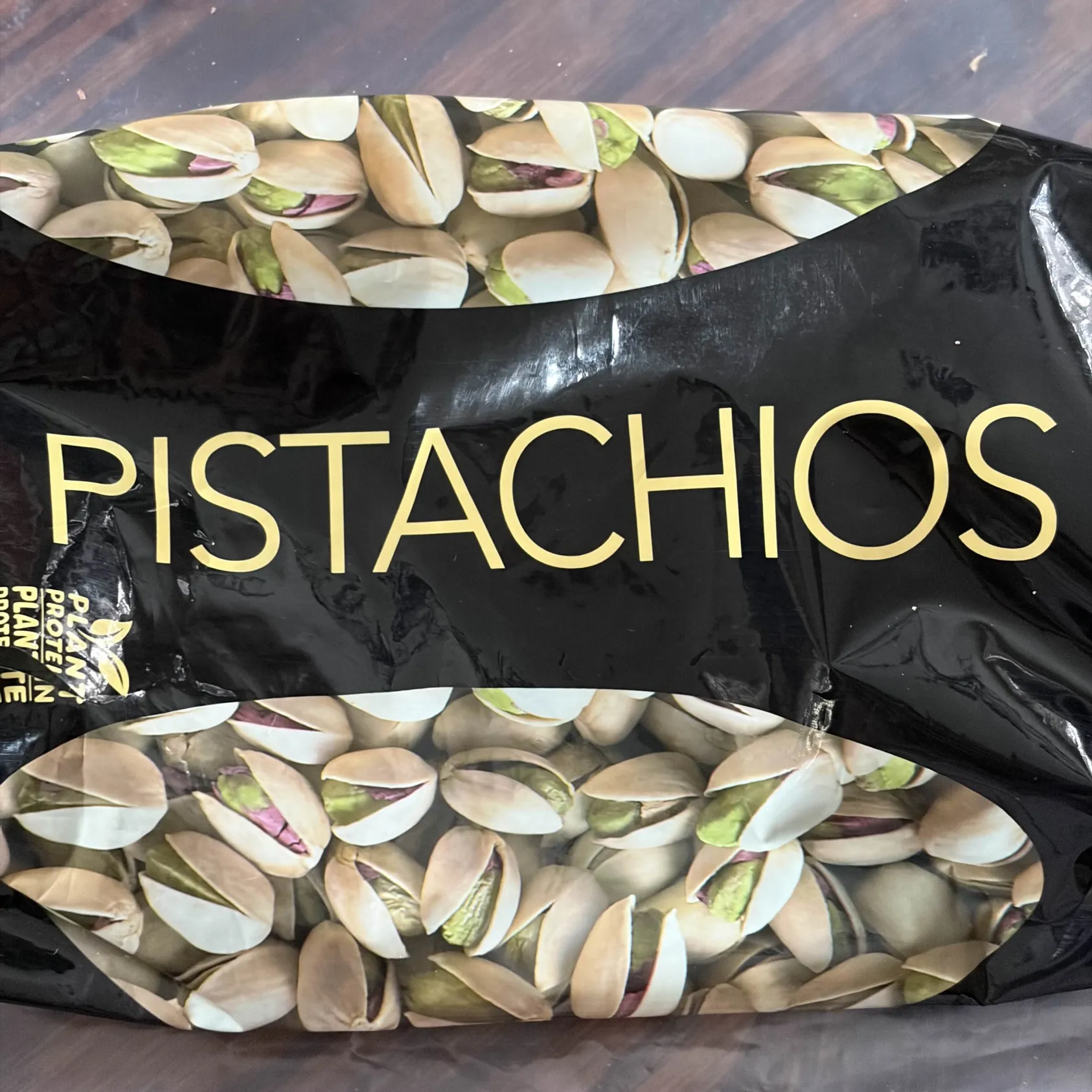 Pistachios falling onto a bowl.