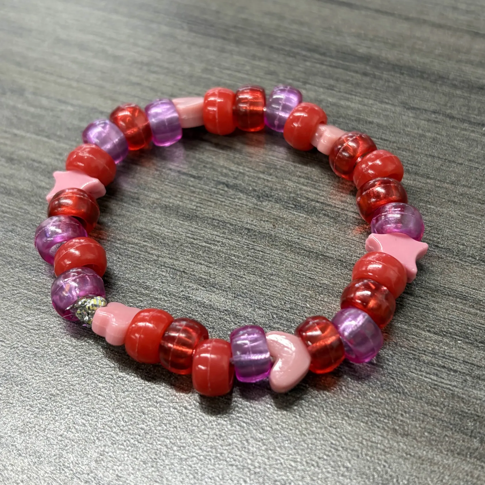 Playing with a kandi bracelet.