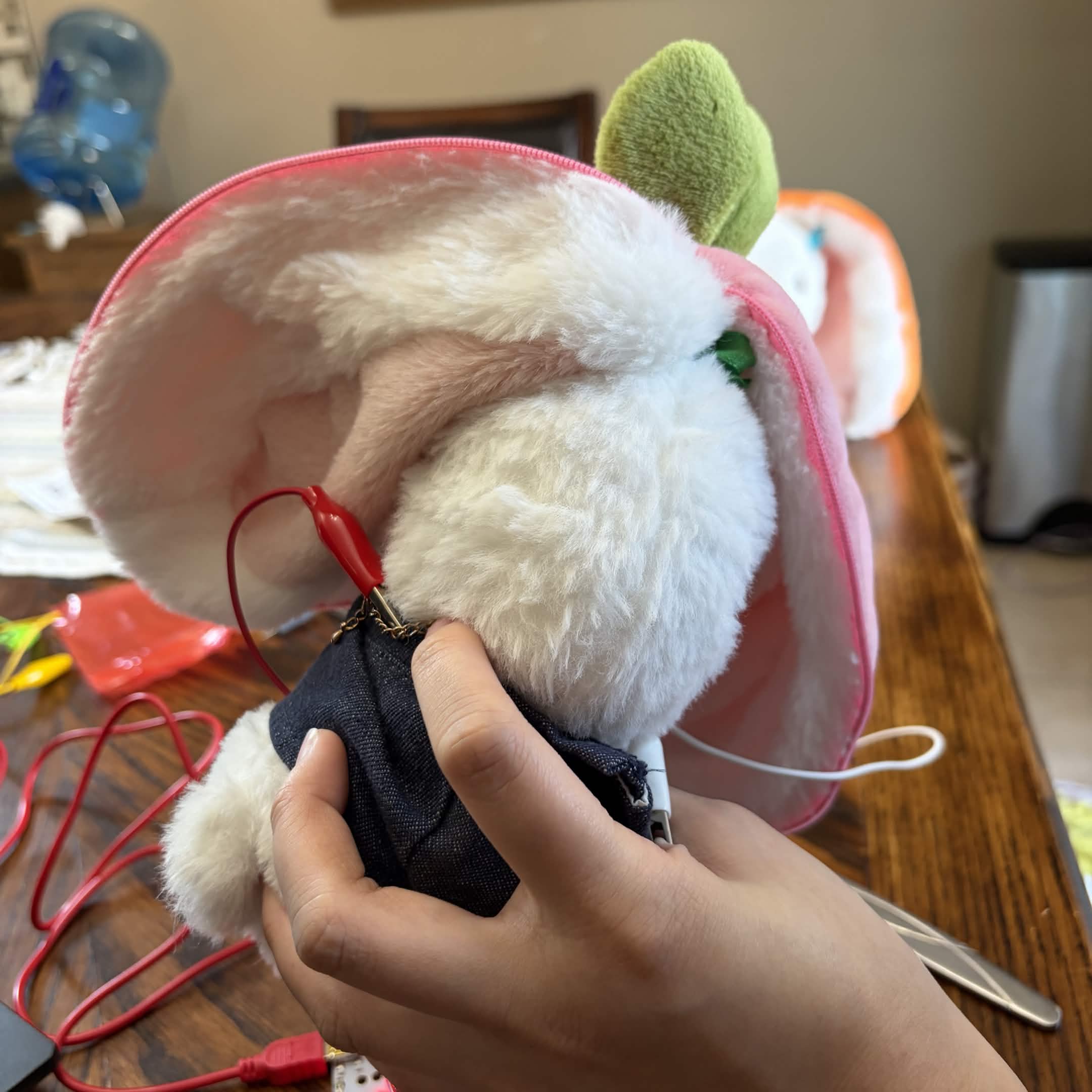 Experimenting with a plush as an input. An alligator clasp is attached to a metal necklace the plush is wearing.