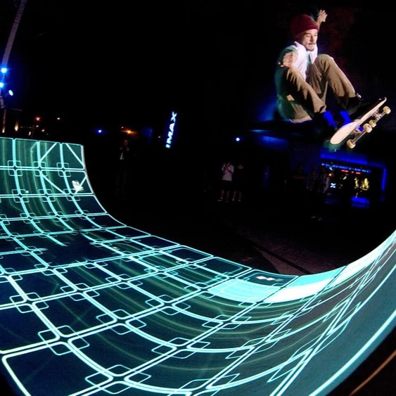 A projection map showcasing a Tron-inspired skateboard ramp.